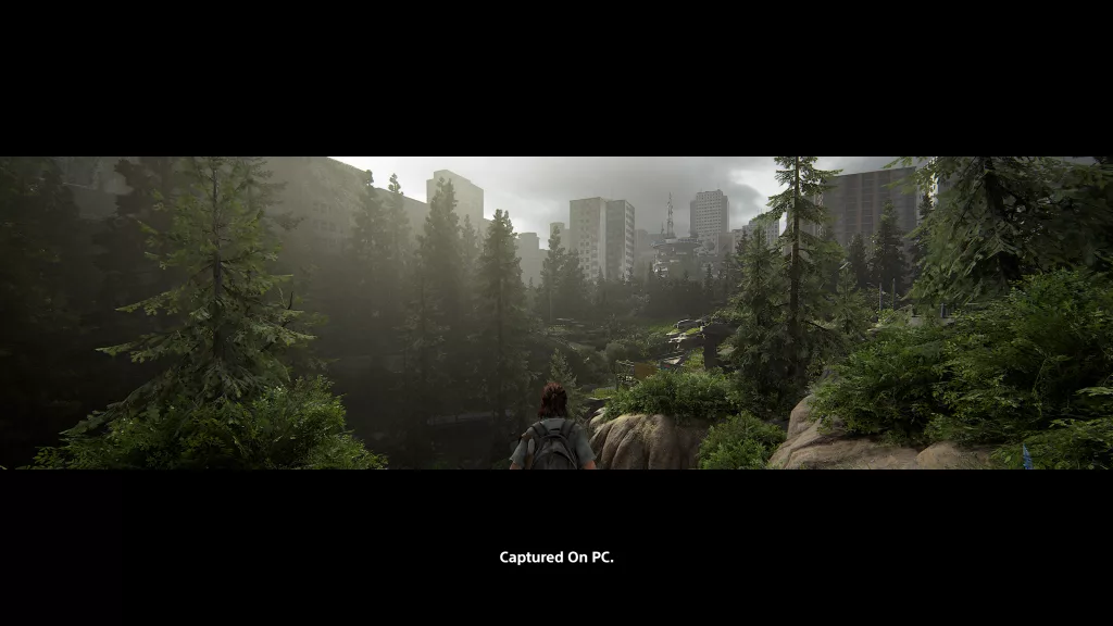 Visual de paisagem indo de uma floresta para vários prédios e sendo admirada por Ellie em Ultrawide.