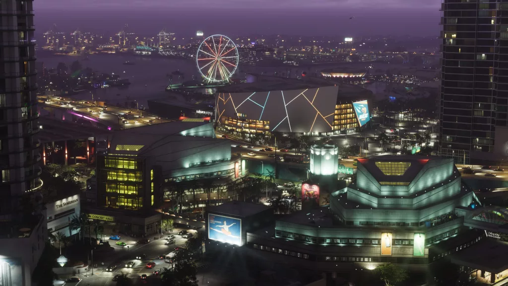 Vice City a noite, com muitos prédios e muita iluminação Neon, ao fundo uma roda gigante.