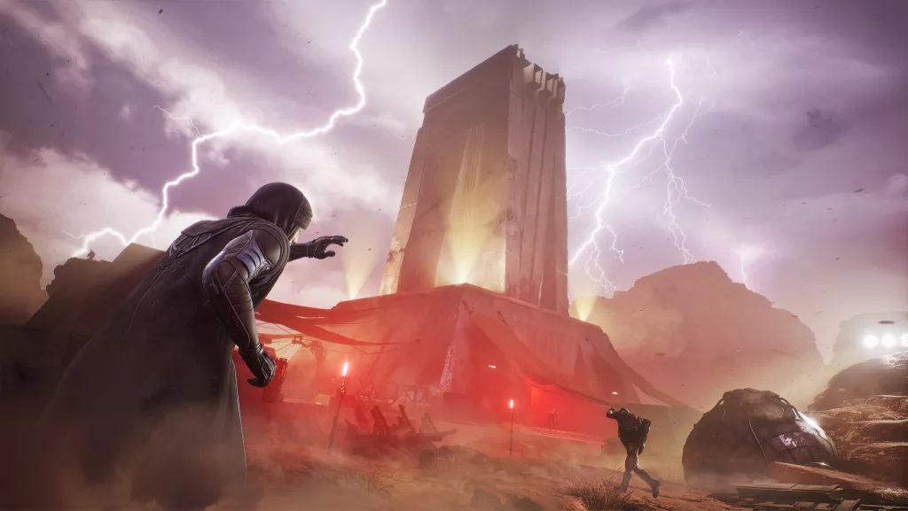 Imagem de uma torre grande no meio do deserto com raios em torno e alguns personagens tentando se proteger do vento.