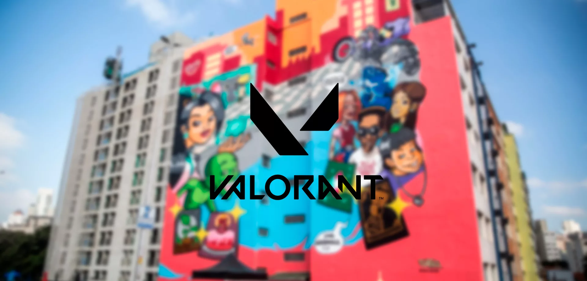 Foto de mural em São Paulo desfocada com Símbolo de Valorant à frente.