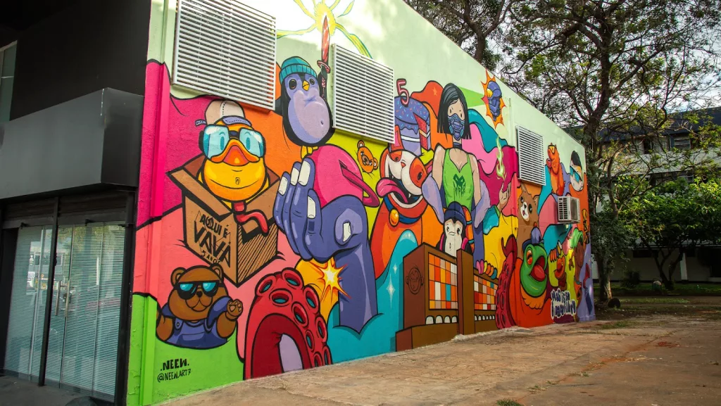 Mural em prédio de Valorant em Brasília próximo a uma praça.