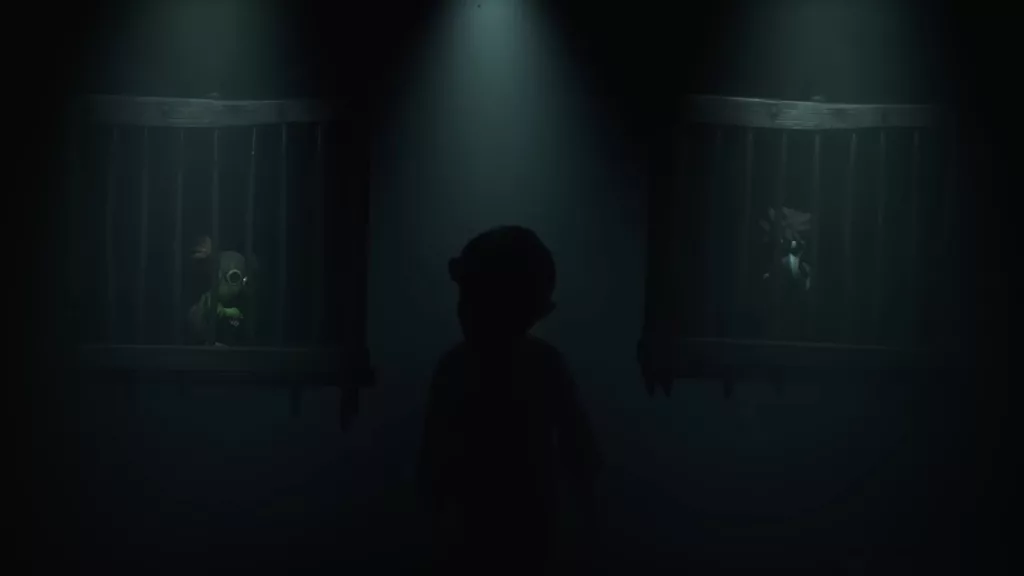 Low e Alone, Protagonistas de Little Nightmares 3 presos em gaiolas e a sombra de alguém muito maior ao fundo.